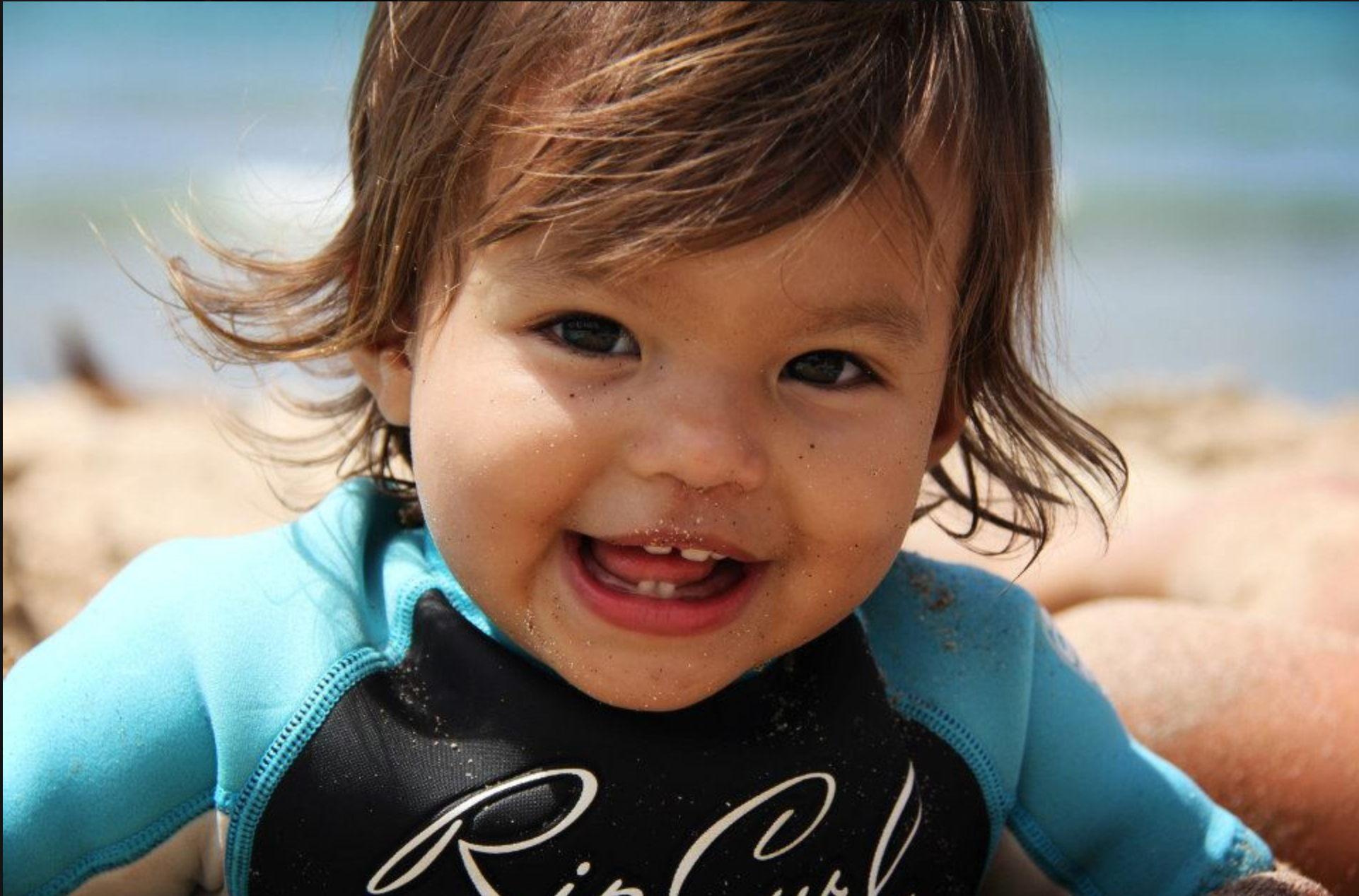 Child smiling on the beach