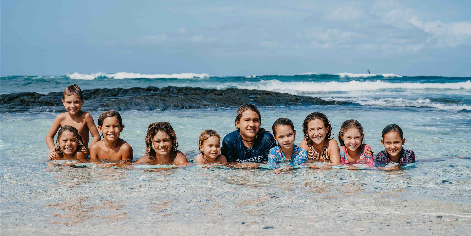 Little Hands Hawaii Home Page - Kids laying in the ocean